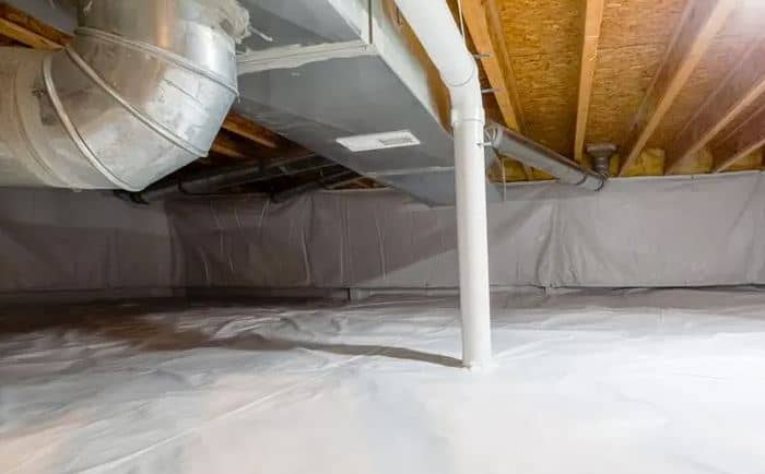 Encapsulated crawl space with a sealed white vapor barrier across the floor and up the piers